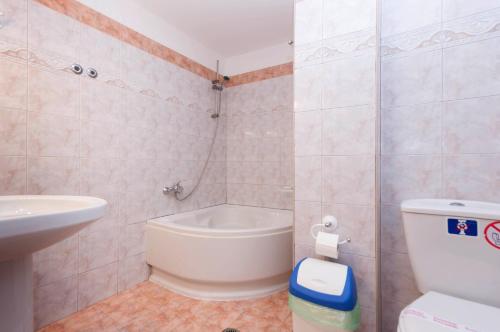 a bathroom with a white toilet and a sink at Villa Baronnos in Gaios