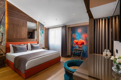 a hotel room with a bed and a chair at Nex Hotel & Spa Istanbul in Istanbul
