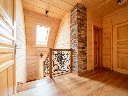 a wooden room with a fireplace and a wooden door at Domki "Na Dziedzinie" z Gorącą Balią in Szaflary