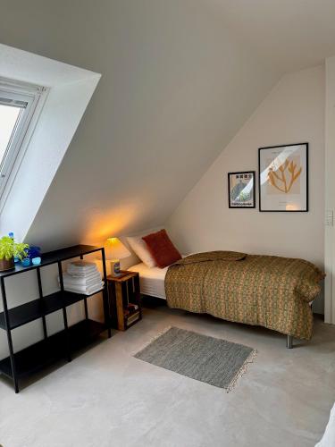 a bedroom with a bed in a attic at Amazing holiday apartment - Clara in Ebeltoft