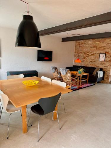 a living room with a wooden table and chairs at Amazing holiday apartment - Clara in Ebeltoft