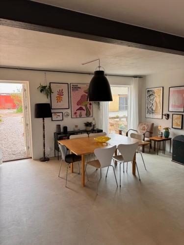 a living room with a dining room table and chairs at Amazing holiday apartment - Clara in Ebeltoft