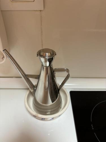 a silver tea kettle sitting on a counter top at Preciosa Casita Boho Chic en la playa in Gran Alacant