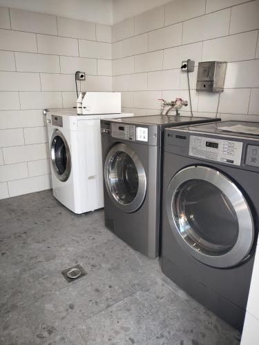 a laundry room with two washing machines and a counter at Mobile Home Aurora Selce in Selce