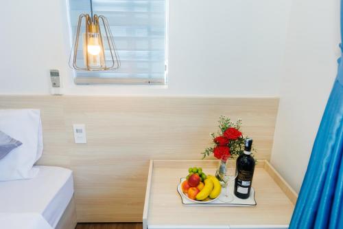 a tray of fruit on a table in a hotel room at Lee House Villa Tam Thanh in Tam Ky