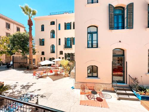 a view from the balcony of a building with tables and chairs at Ostello Bello Palermo in Palermo