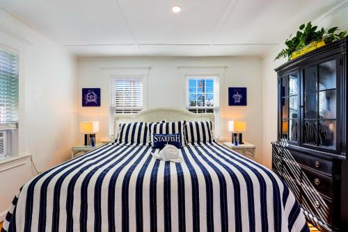 a bedroom with a black and white striped bed at Seaside Serenity in Bradenton Beach