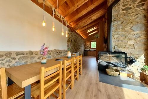 a dining room with a table and a fish tank at Cal Cumell, Allotjament turístic in Aransá