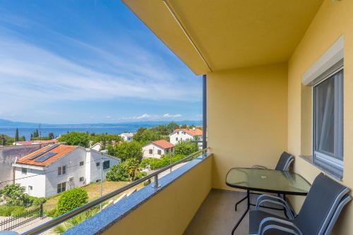 a balcony with a view of a city at Apartmani Tena in Njivice