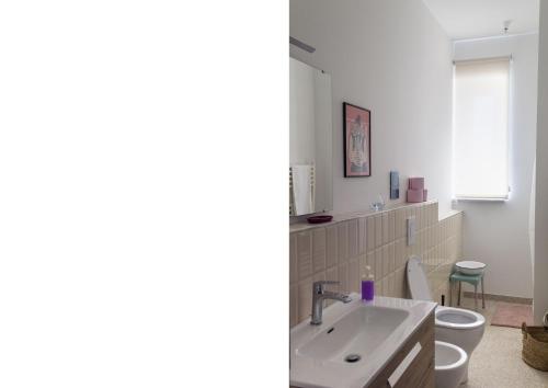 a bathroom with a sink and a toilet and a mirror at Dazicalò in San Giovanni Gemini