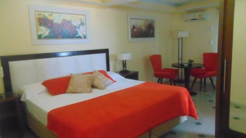 a bedroom with a bed and a table and chairs at Hotel Pousada Laje de Itauna in Saquarema