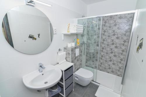 a bathroom with a sink toilet and a shower at Memory Box Apartman - Šibenik in Šibenik