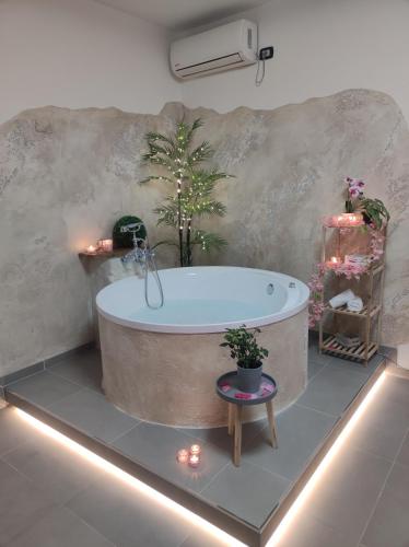 a bathroom with a tub with lights and plants at Emme House Bed&Breakfast in Pontecorvo