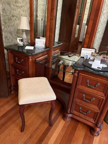 an office with a desk and a chair and a dresser at Grand Colonial Bed and Breakfast in Herkimer