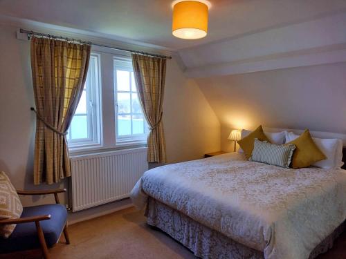 a bedroom with a bed and a large window at Chough's Nest Hotel in Lynton