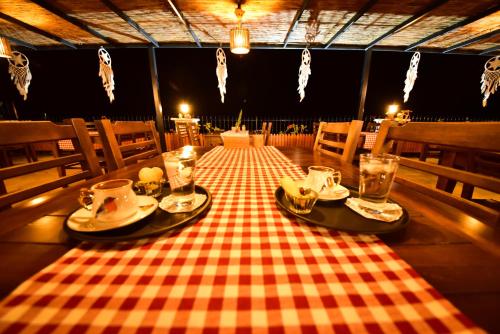 a table with a checkered table cloth on it at Zūhre Cafe Bungalow in Demre