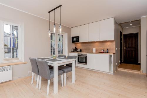 a kitchen with a table and chairs in a room at Vingi Familyhouse with free parking and sauna in Pärnu