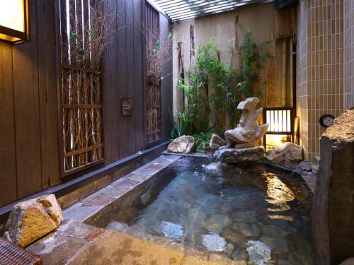a koi pond in the middle of a house at Dormy Inn Premium Nagoya Sakae in Nagoya