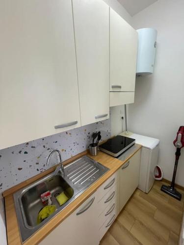 a kitchen with a sink and a counter top at Appartamento Celeste piazza Mazzini Spiaggia in Lido di Jesolo