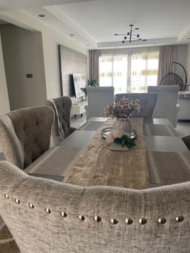 a living room with a couch and a table at Silverstone Apartments Nairobi, Kilimani in Nairobi