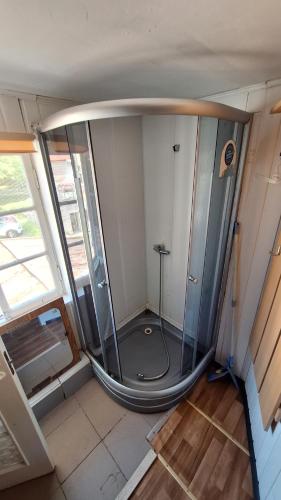 a room with a glass shower in a house at Apartments Londa in Jūrmala