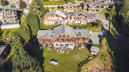 an aerial view of a large house on a hill at Les Chalets d'Adelphine & SPA in Les Gets