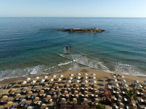 an aerial view of a beach with umbrellas at High Beach Resort in Malia