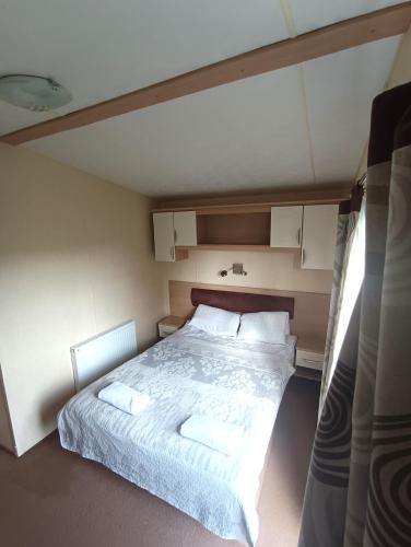a bedroom with a large bed with two pillows at Ośrodek Wypoczynkowy Barbara in Gródek Nad Dunajcem