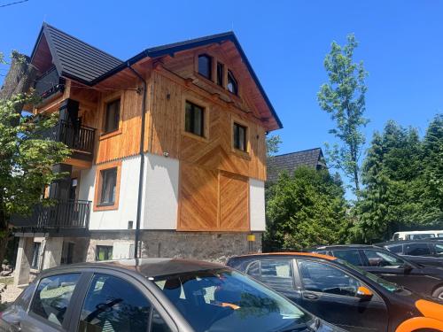 a building with a wooden house on top of it at Studio dla 2 osób Tatra-Dream in Zakopane