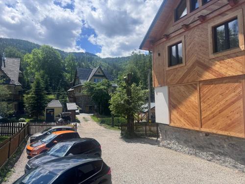 a row of cars parked in front of a house at Studio dla 2 osób Tatra-Dream in Zakopane
