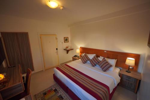a hotel room with a bed with two pillows at Petra Plaza Hotel in Wadi Musa