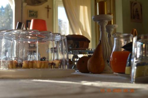 a table with jars of donuts and orange juice at Villa Dacia in Guiglia