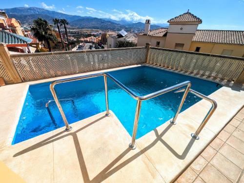 a swimming pool with a metal rail around it at Viña Home in Torre del Mar
