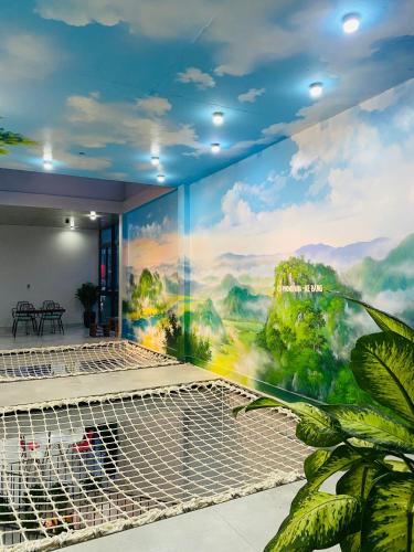 a mural on the wall of a room with at Celia Boutique Hotel in Phong Nha