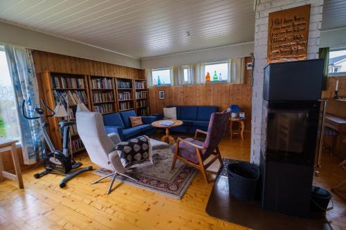 sala de estar con sofá y chimenea en Nordbo - unik plass med utsikt over Rambergstranda en Ramberg