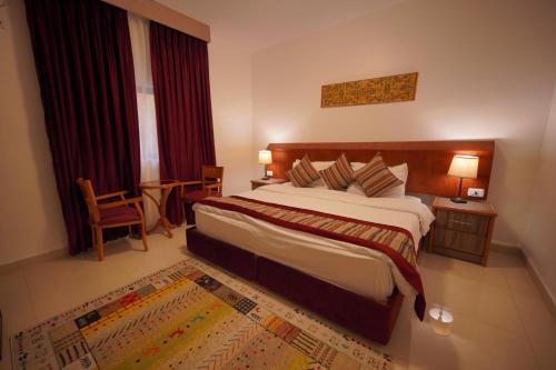a hotel room with a large bed and a window at Petra Plaza Hotel in Wadi Musa