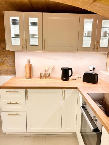 a kitchen with white cabinets and a counter top at MCC St Rita in Il-Furjana