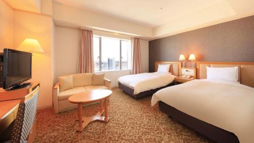 Postel nebo postele na pokoji v ubytování Crest Hotel Kashiwa