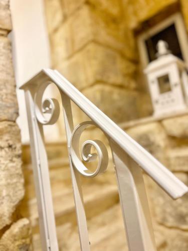 a white railing in front of a stair case at MCC St Rita in Il-Furjana
