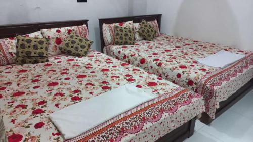 two beds sitting next to each other in a bedroom at Sea Zone Hotel Nilaveli in Nilaveli