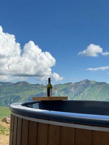 a hot tub with a bottle of wine and two glasses at Gogi Resort in Gudauri