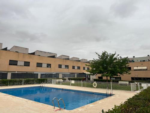 a swimming pool in front of a building at Ánade Real Guest House in Daimiel