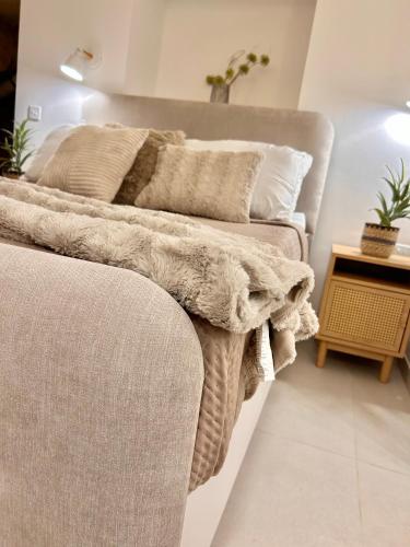 two beds in a living room with a blanket at MCC St Rita in Il-Furjana