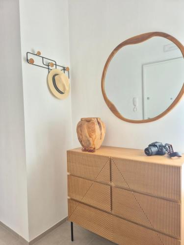 a mirror on top of a dresser in a room at Casita Isabella in Vieste
