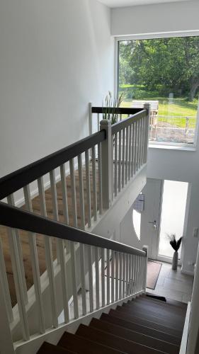 a staircase in a house with a large window at Familientraum in Großweitzschen