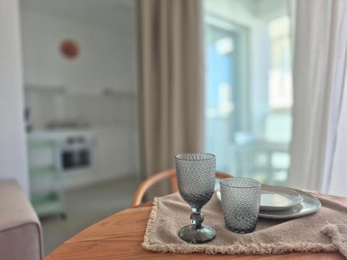 a table with a plate and a wine glass on it at Casita Isabella in Vieste