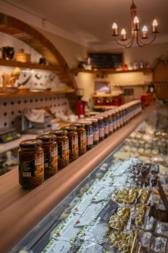 a display case in a bakery with jars of food at Ubytování Kroupa in Dolní Dunajovice