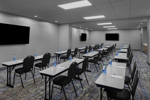 a room with tables and chairs with water bottles on them at Hampton Inn Cleveland-Downtown in Cleveland