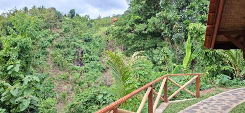 a wooden staircase leading to a hill with trees at Uma Nirmala Aling-Aling in Singaraja