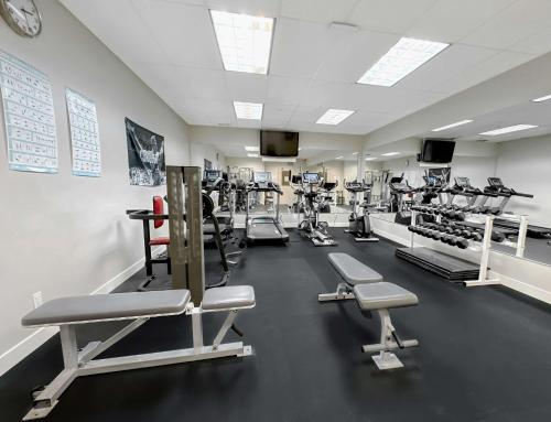a gym with a lot of treadmills and machines at Coast Abbotsford Hotel & Suites in Abbotsford